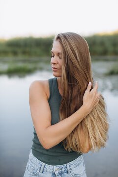 Young woman enjoying peaceful nature moment by river