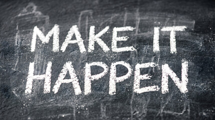 Fototapeta premium Handwritten chalk motivational quote on blackboard. Inspirational make it happen lettering for success and goal achievement.