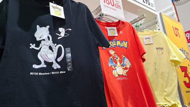 close up view of colorful pokemon graphic t shirts featuring mewtwo mew charizard pikachu hanging on display rack inside Uniqlo retail store on July 21, 2026 in Bangkok, Thailand.