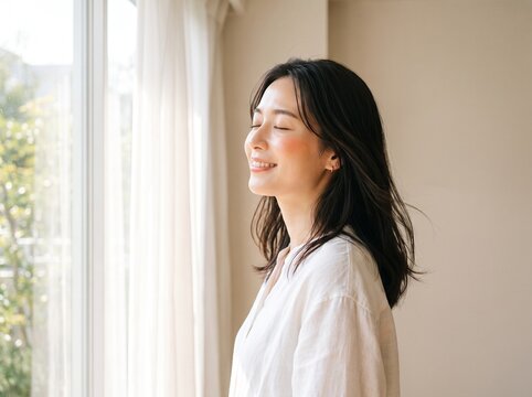 Peaceful Japanese Woman Enjoying Fresh Morning Air Beside a Bright Window with Radiant Healthy Skin in Natural Wellness and Skincare Commercial