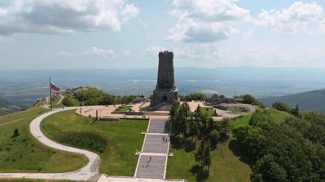 Shipka Monument aerial drone view of stone tower staircase mountain peak panorama Stara Planina Bulgaria summer travel destination