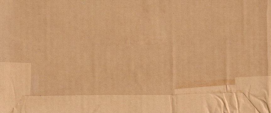 Frame made of brown beige old paper with packet tape, cardboard carton packaging pattern texture background banner panorama