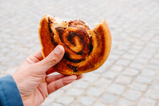 man eating a kanelsnegl in Copenhagen