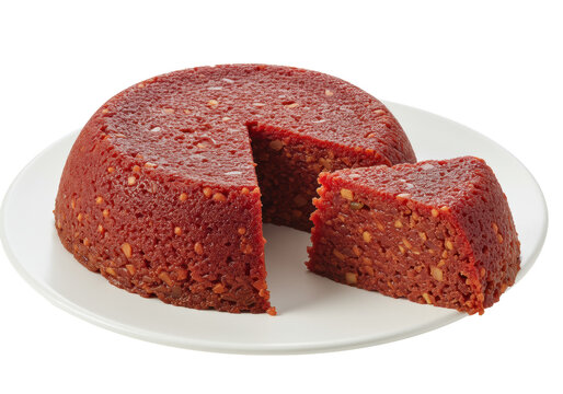 A dome-shaped cuscuz paulista dish, deep red and firm, on a transparent ceramic plate against a transparent background with copy space, a perfect slice removed revealing granular texture.