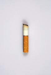 a cigarette stub on white background © saturno