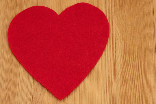 Blank red heart on a wood desk for romance and dating
