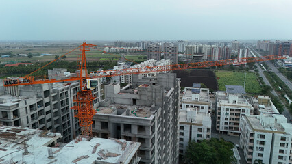 Obraz premium Aerial Drone View of High Rise Residential Construction Site with Tower Crane and Modern Urban Development