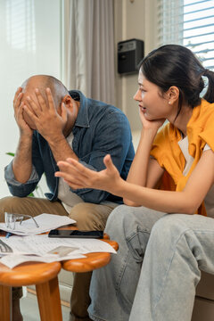 Young couple live together planning future and managing finances and expenses. They argue and have financial problems struggling to pay bills and accumulating debt. stress in raise tax rate crisis