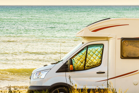 Caravan recreational vehicle camping on sea shore.