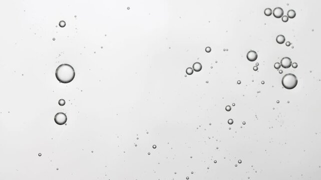 Liquid cosmetic texture with bubbles top view, serum sample.