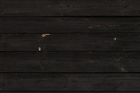 Black background. Texture of old charred wood.