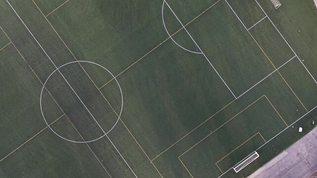 Aerial drone view of an empty green soccer field with white lines sports infrastructure and outdoor recreation
