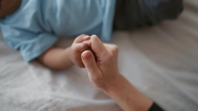 Unconditional love of mother and child, close up view of female and infant hands . Happiness and tenderness of moments, careful black woman spending time with infant girl or boy, family relationship