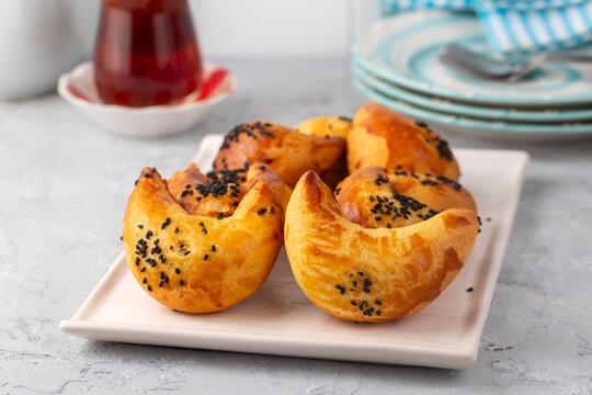 Freshly baked Turkish ay coregi crescent pastry with chocolate filling and black cumin seeds on plate