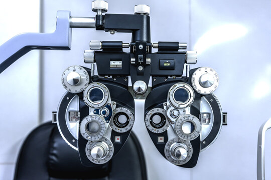 Close up modern digital phoropter and autorefractor equipment using for eyesight examination, precise vision testing, eye assessment, and prescribing corrective eyeglasses in modern optical clinic
