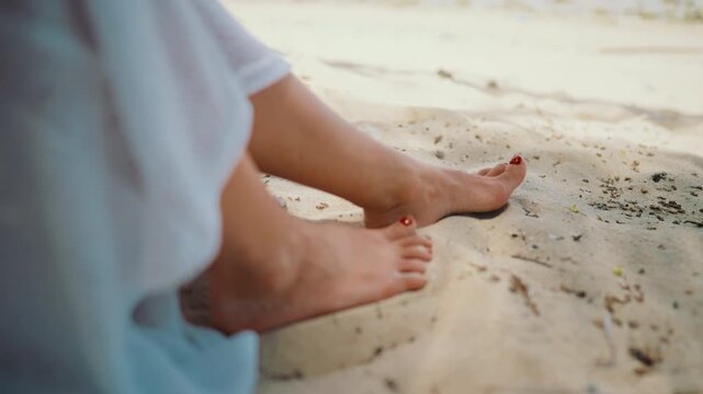 Rest on beach in hot summer day, closeup view of graceful female feet on sand. Enjoy calmness and seclusion in holidays and vacation, escape from city, work and troubles, feel happiness and tan