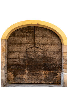 Medieval style large rustic wooden portal with a round masonry arch, heavily decorated with protective iron metal studs and featuring a built-in smaller pedestrian door Isolated on white clipping path