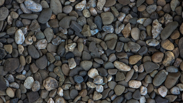 Natural river pebbles texture close up full frame as organic stones background