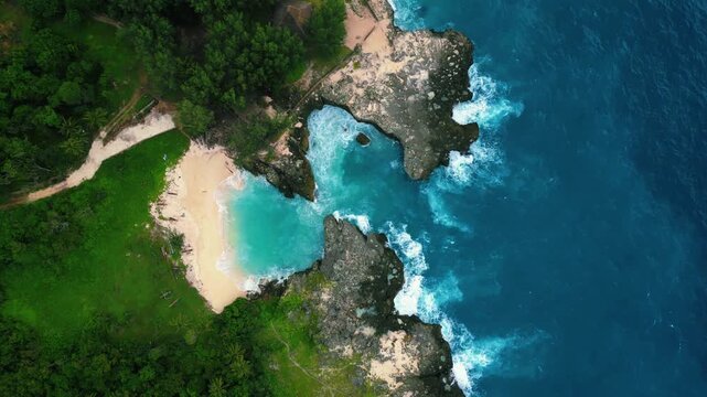 Turquoise waters framed by limestone cliffs at Mandorak Beach in Sumba Island, Indonesia