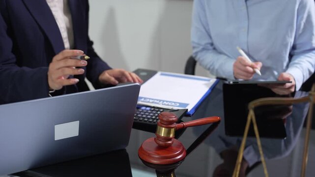 Business lawyers and professionals meeting on digital nomad visa application with laptop and legal documents in a modern workplace.