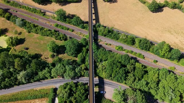 Aerial view of Edstone Aqueduct, narrowboat crossing bridge over railway and road
