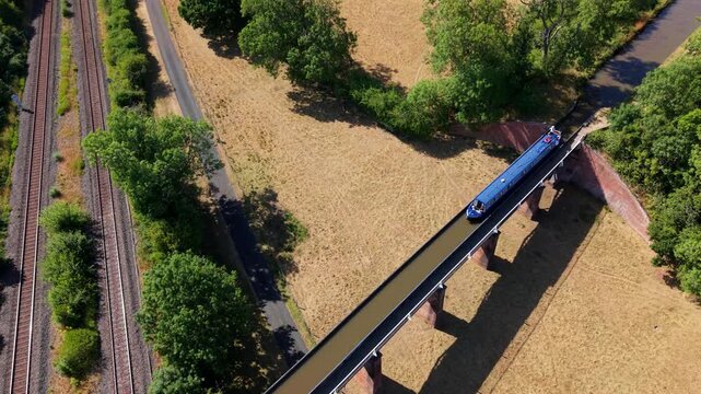 Aerial view of canal narrowboat navigating the historic Edstone Aqueduct in Warwickshire