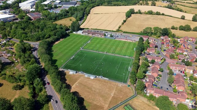 Aerial view of local amateur football match played on grass pitch in Redditch, UK