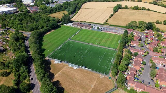 Aerial view of local amateur football match played on grass pitch in Redditch, UK