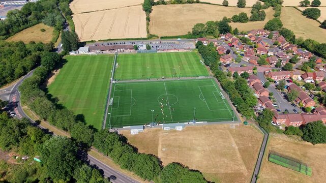 Aerial view of local amateur football match played on grass pitch in Redditch, UK
