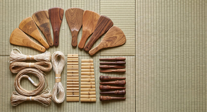 Overhead flat lay of Japanese Satsuma Biwa lute tools on Tatami mat