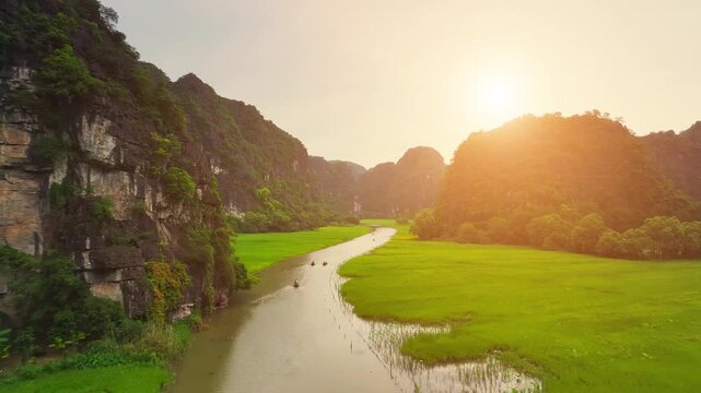 Aerial view of Tam Coc landscape with limestone mountains, river and rice field on Ngo Dong stream, Ninh Binh province, Vietnam