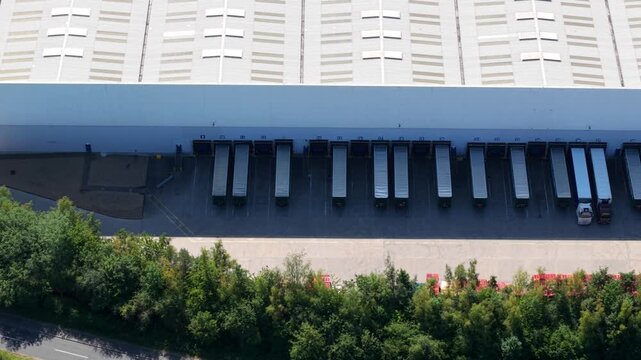 Aerial View of Rows of Heavy Goods Vehicles Docked in Loading Bays at Distribution Hub