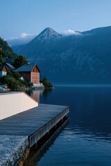 Fototapeta premium Wooden corner pier beside quaint lakeside houses with mountain peaks for calm wallpaper and banner background