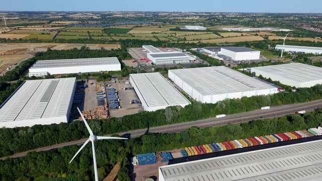 Aerial view of logistics distribution warehouses and wind turbines at DIRFT near Daventry UK