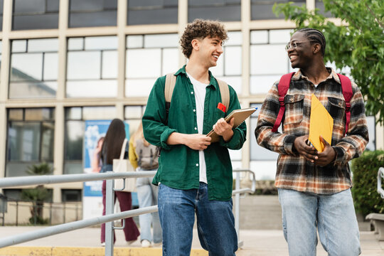 College Student friends Walking University staircase talking and laughing after lectures and exams