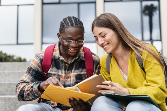 Two student friends learning together preparing for exams and working on University project