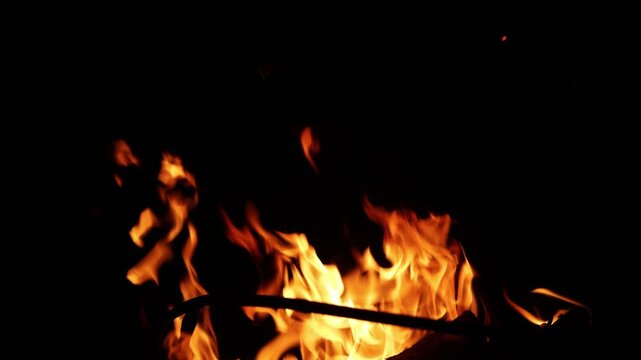 Close-up of vibrant orange flames dancing against a dark background