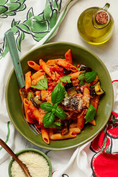 Pasta alla Norma with eggplant, tomato sauce, basil and pecorino cheese.selective focus