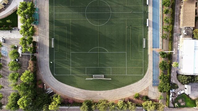 Sports education and athletic training concept aerial drone view of two empty soccer fields with running tracks