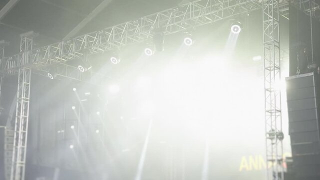 Bright concert spotlights illuminating outdoor festival stage
