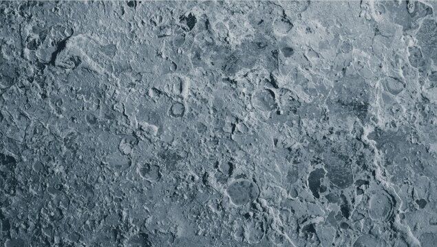 Rocky lunar surface texture with craters and shadows
