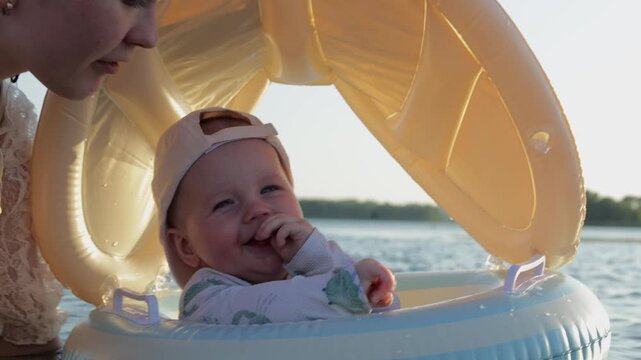 Adorable baby enjoys a safe and fun boat ride on calm lake water with adult supervision