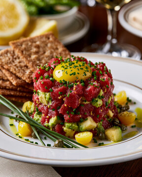 Gourmet Tuna Tartare with Avocado and Raw Egg Yolk Served with Crackers