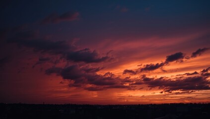 Fototapeta premium Vibrant Sunset Sky with Dramatic Clouds over a Cityscape
