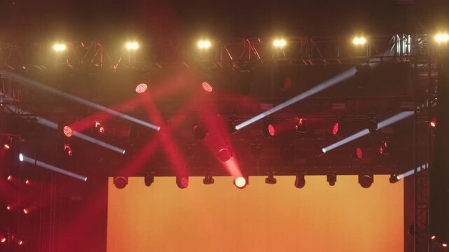 Red stage spotlights and lighting truss at outdoor concert