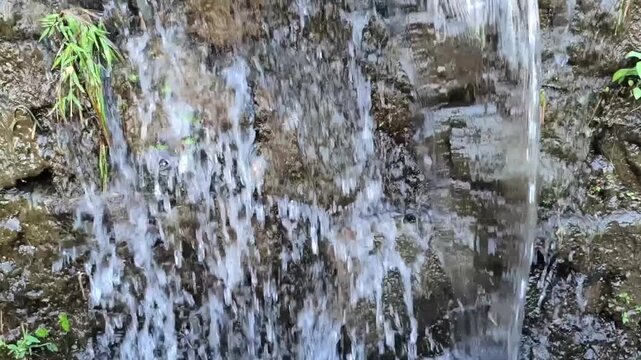Small Waterfall Flowing Through Rocks, Close Up Slow Motion Nature Background