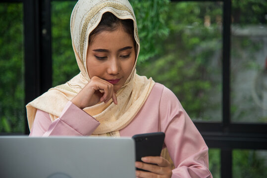 Muslim women working. Young Asian arabian muslim women working summary report business graph chart. Crop arabian muslim women working business report graph chart. Portrait woman wear hijab smile