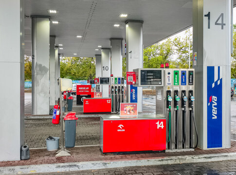 Prague, Czech Republic - July 23, 2026: ORLEN fuel dispenser with gasoline and diesel nozzles, digital display and convenience store at modern service station, transportation infrastructure