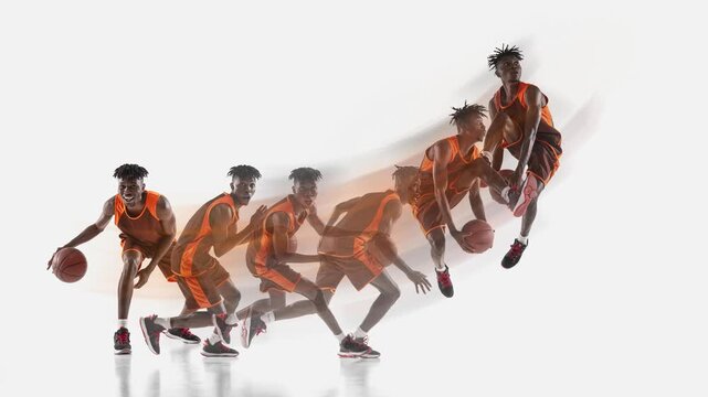Black male basketball player dribbling and jumping with motion trail on white background. Concept of athletic performance advertising, basketball motion analysis, frame by frame sports campaign.