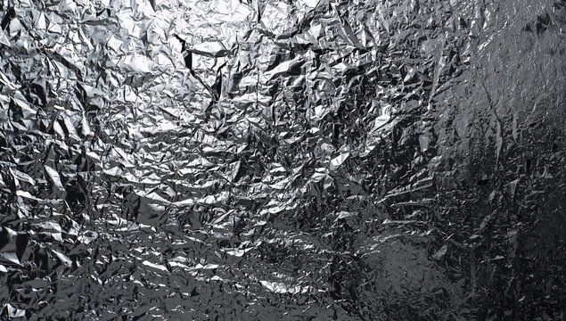 Crumpled Silver Foil Textured Background with Reflective Shimmer